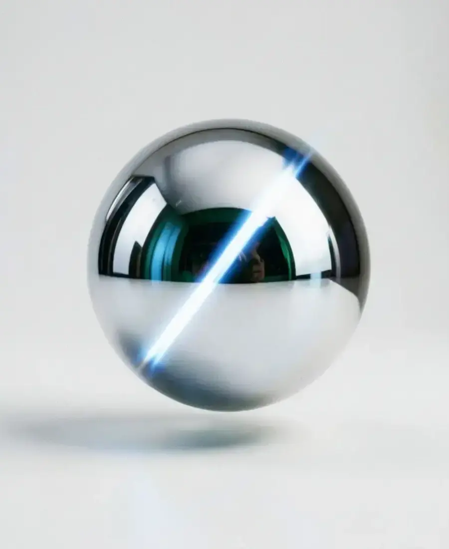 Polished chrome sphere reflecting workshop light on a pearl surface, visual anchor of the Inflpan finishing line